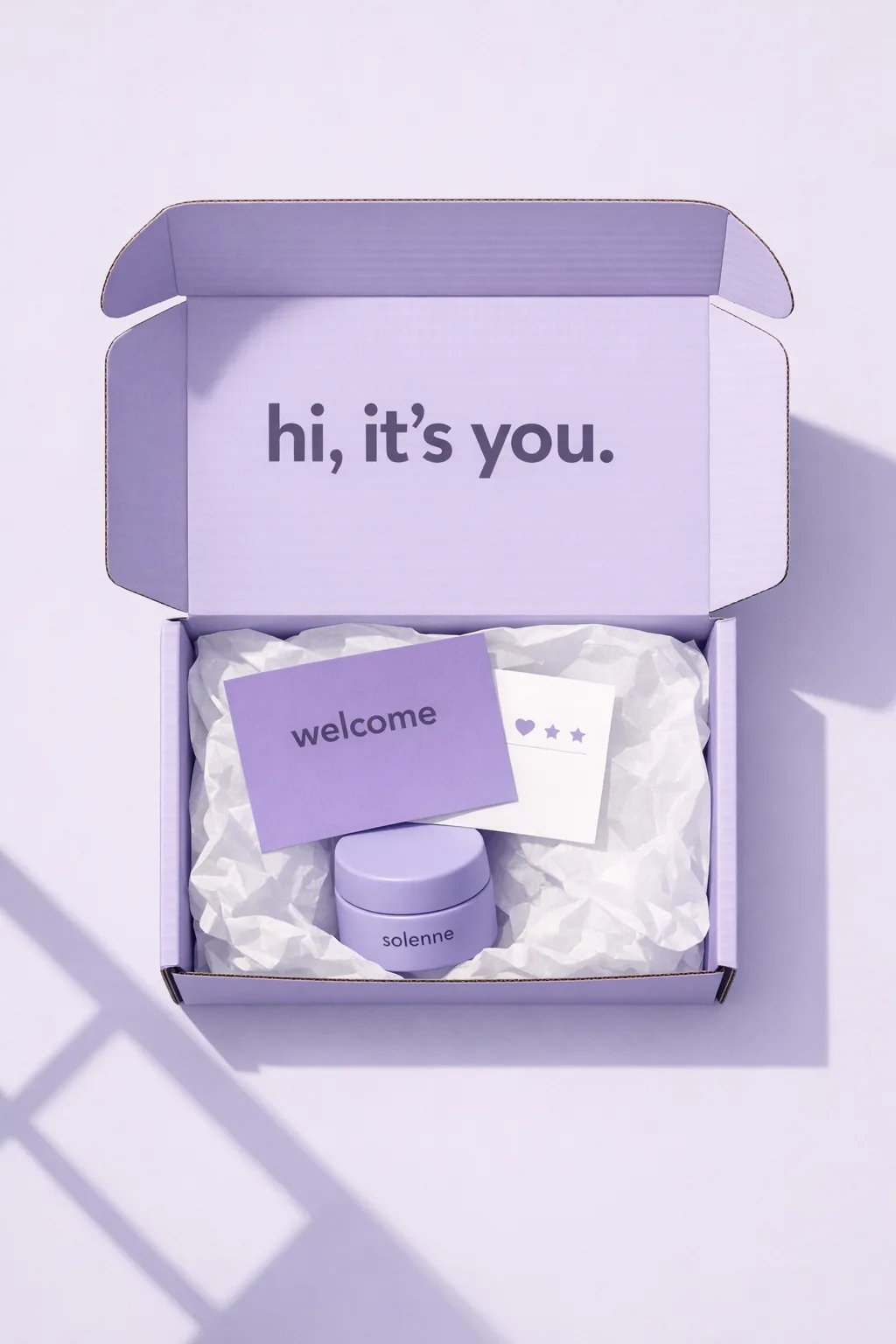 Open lilac mailer with a printed lid and welcome card